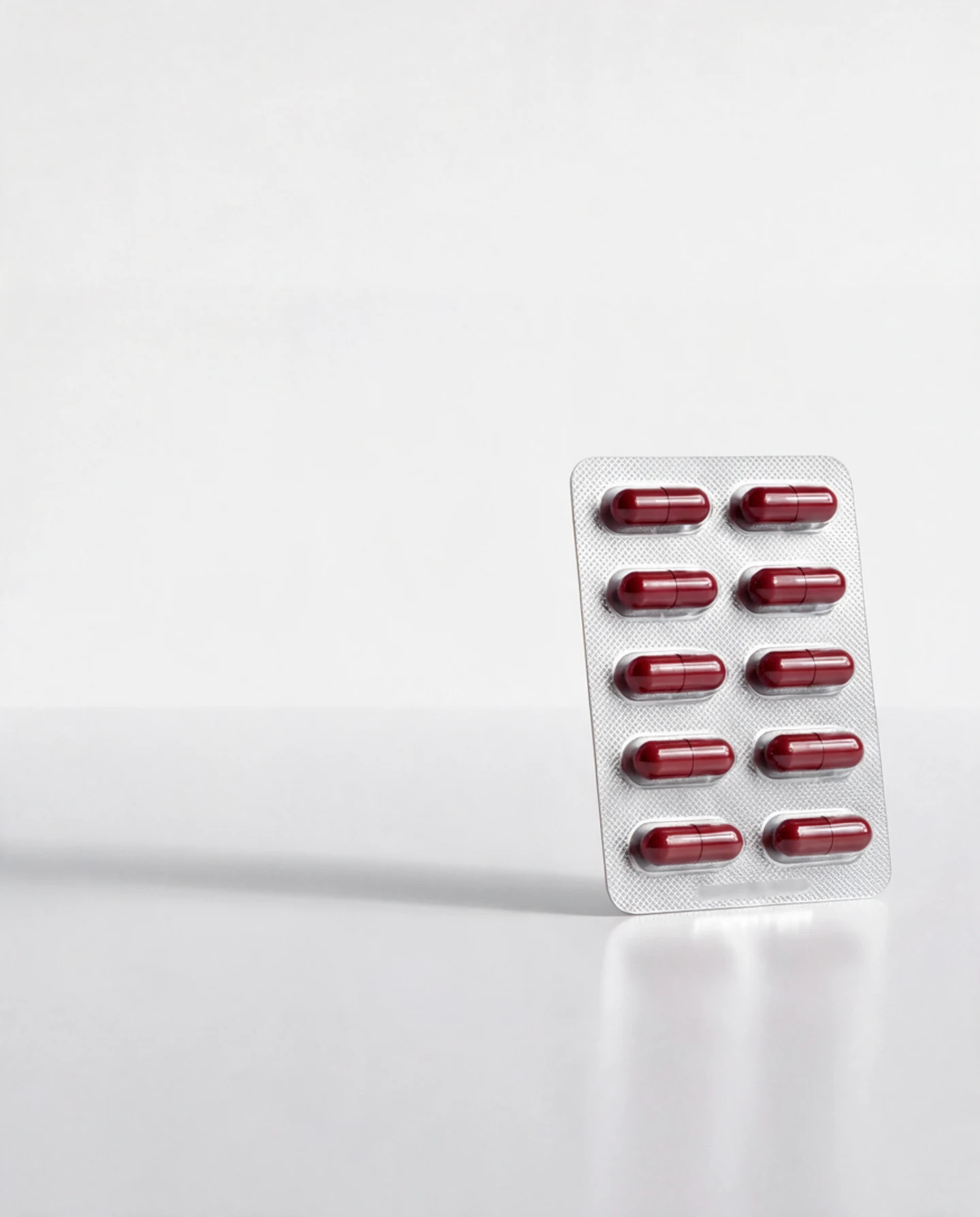Blister strip containing ten red Qualimin capsules