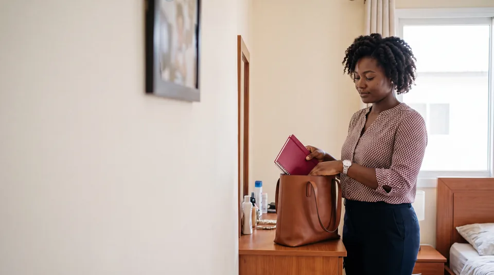 Ghanaian woman preparing her work bag before leaving home